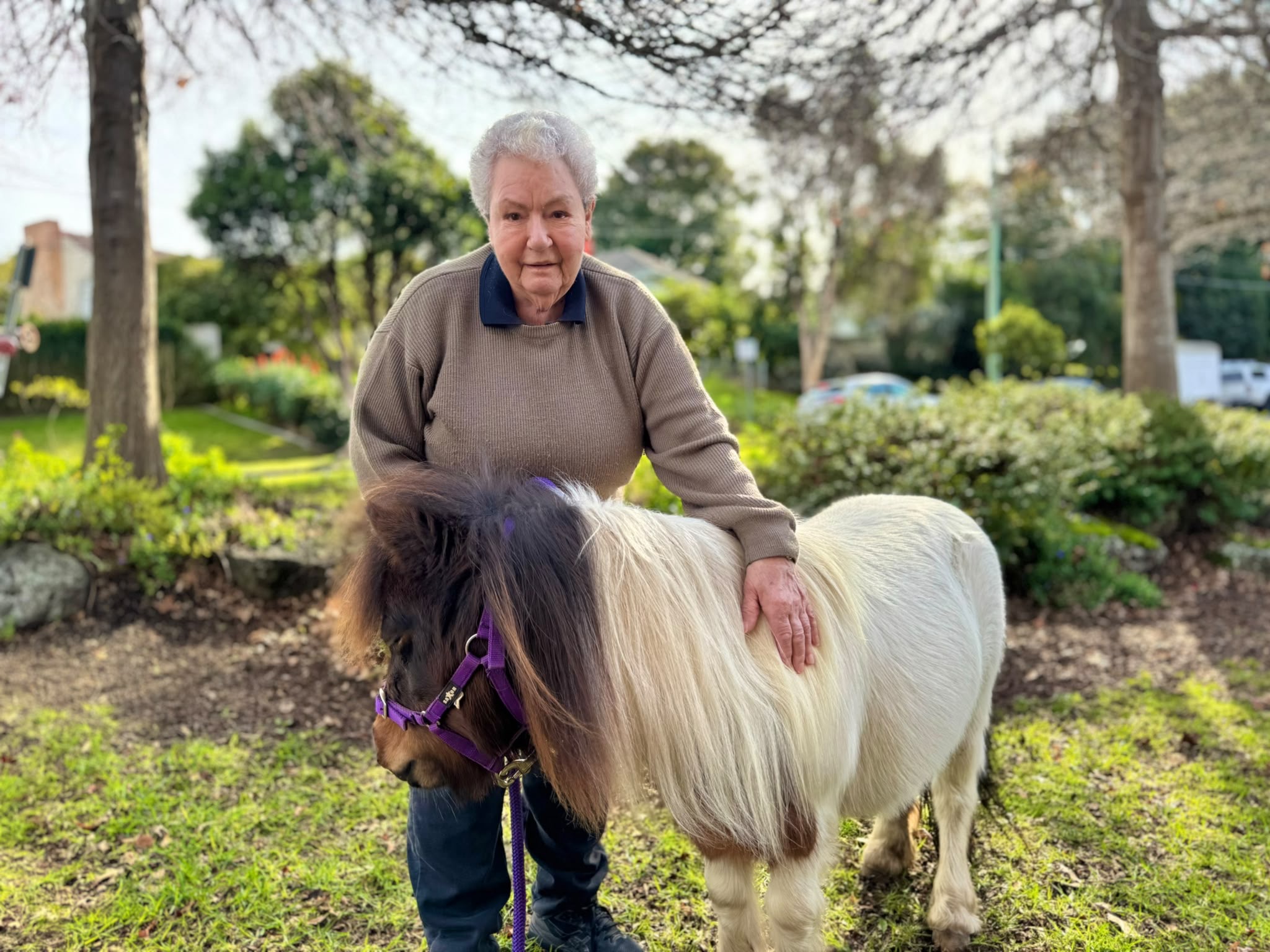 Peanut sharing a gentle outdoor moment during an aged-care visit
