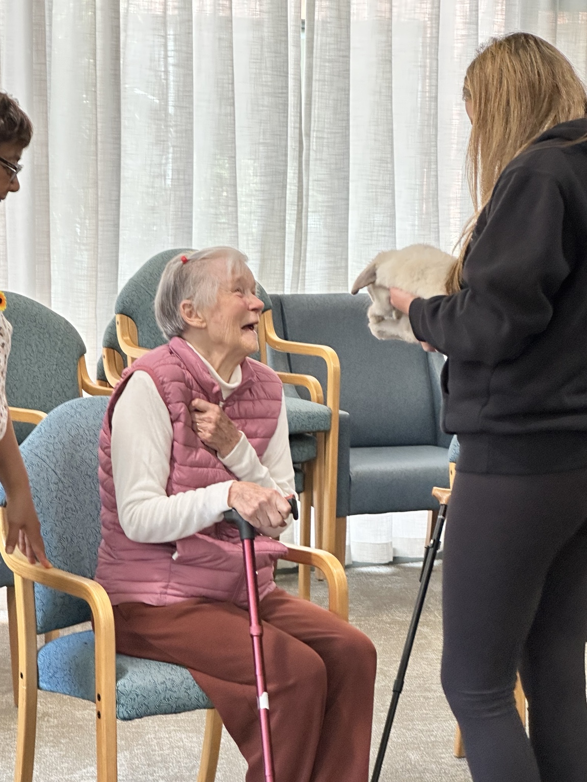 A resident smiling during a supervised animal interaction